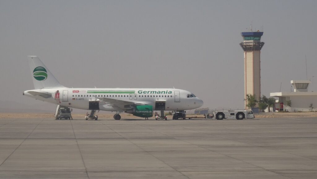 Marsa Alam International Airport photographed in 2015; illustrative end-of-trip transfer scene.